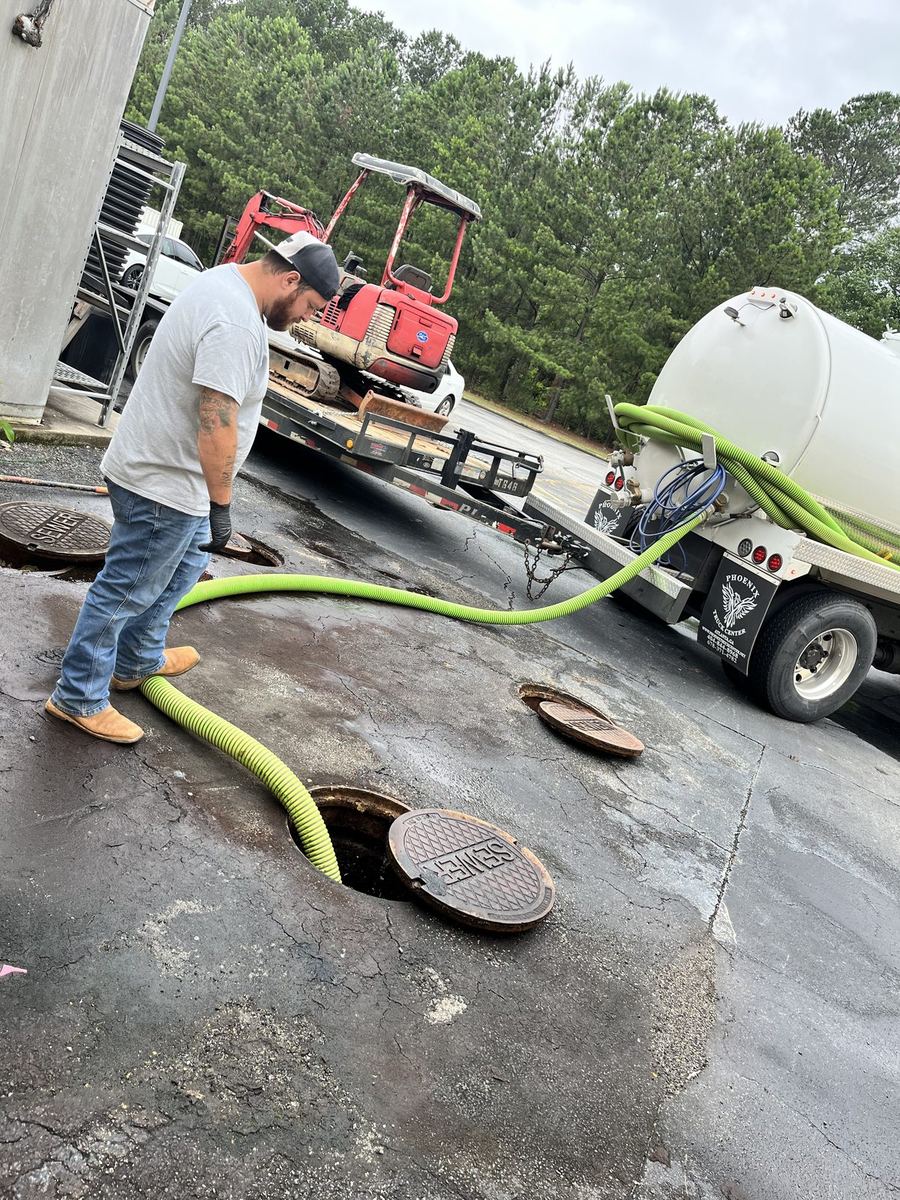 Vacuum truck performing septic tank pump-out